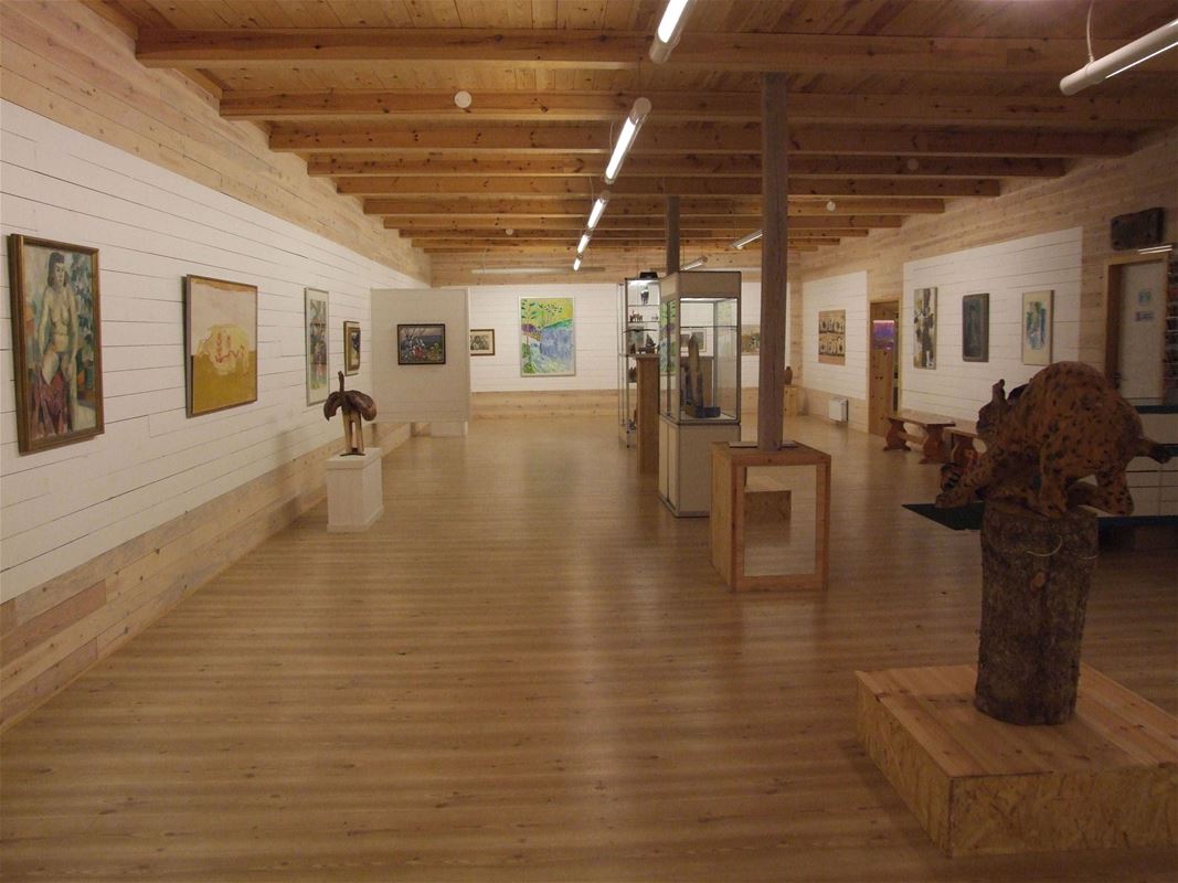 Exhibition hall with paintings on the walls.