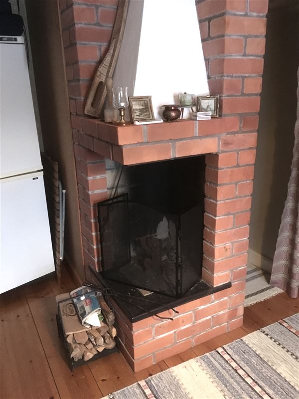 Open fireplace of red brick. 