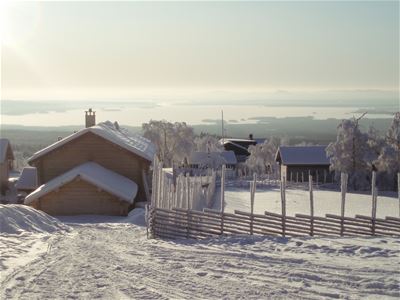 Wiew over timber cottages and a typical dalecarlian fence during a winter morning. 