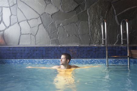 A man is bathing in the pool. 