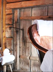 Detail of towels on a spa bath in front of an old wooden door. 