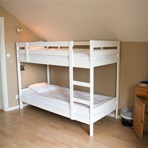 A white bunkbed in a room.