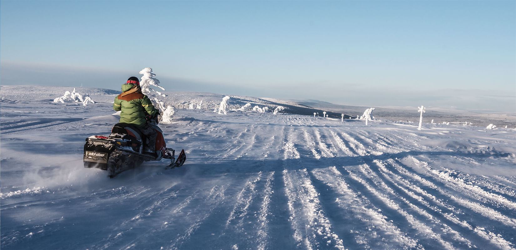A driver on a scooter drives from the camera out onto the white expanses.