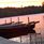 Solnedgång och roddbåtar
