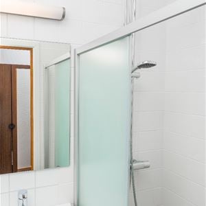 A shower with a glass wall.