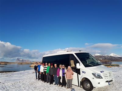 Guests stand in front of the minibus