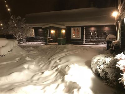 Bondasgården in the evening with snow in teh garden. 