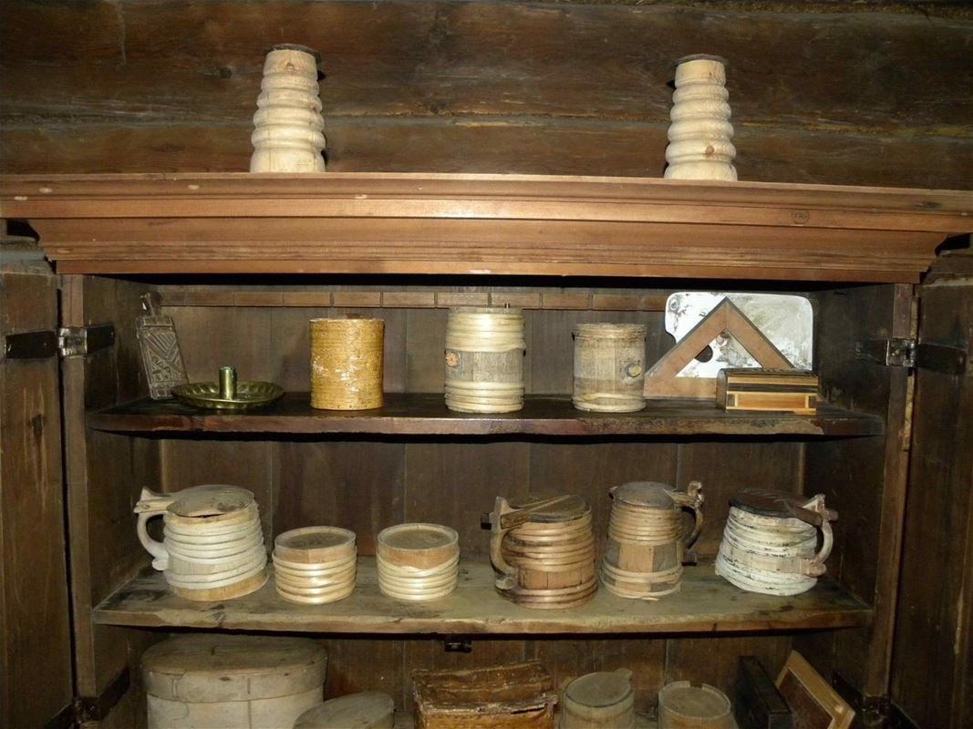 Shelf with different wooden cups.