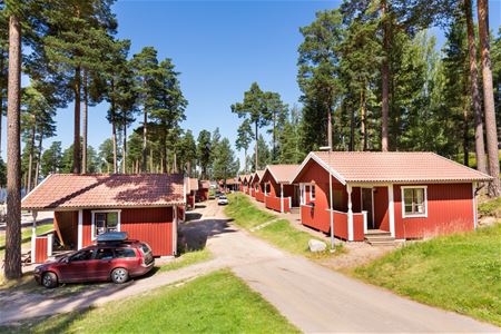 Red cabins along a smaller road. 