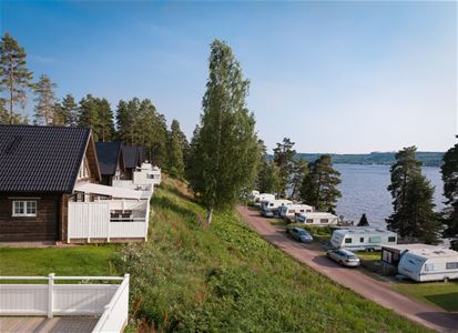 Stugor och husvagnar vända mot sjön.