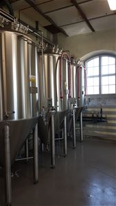 3 large tanks filled with organic beer.