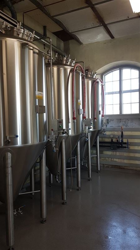 3 large tanks filled with organic beer.