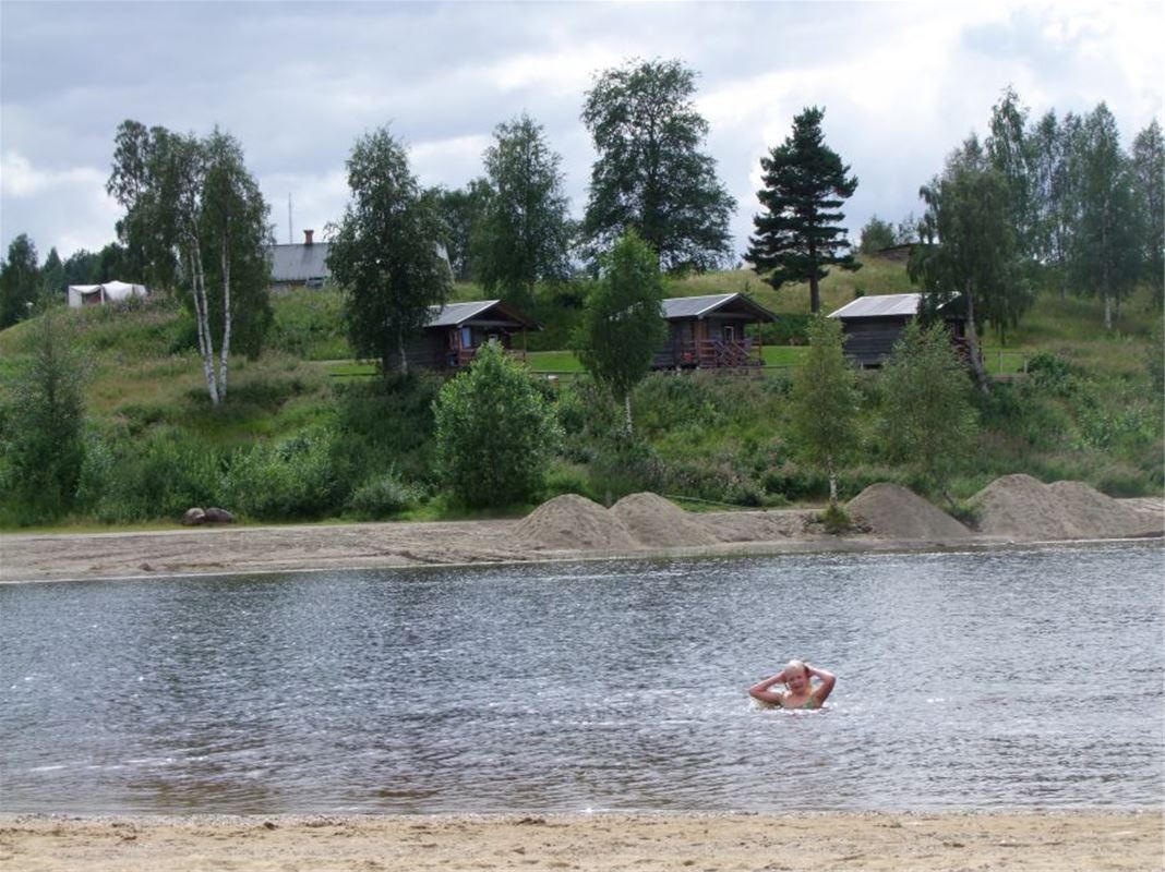 A woman swimming in the lake.