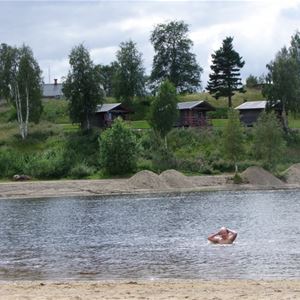 A woman swimming in the lake.