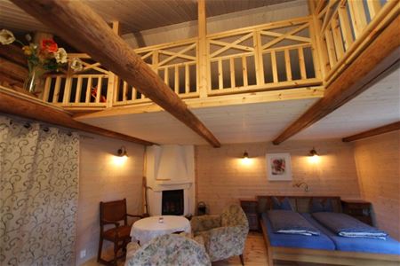 Large room with double bed, open fire place and a loft.