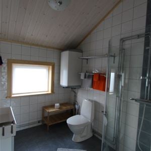 Bathroom with tiled walls and floor. 