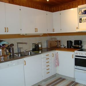 Fully equped kitchen with a stove, dishwasher and f ridge.