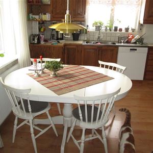 The kitchen with a table and four chairs.