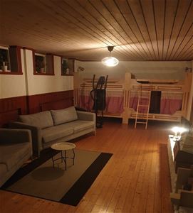 Large room with two sofas and two bunk beds.