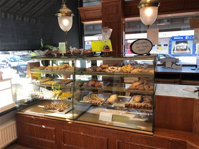Interior image, pastries in glass cases.