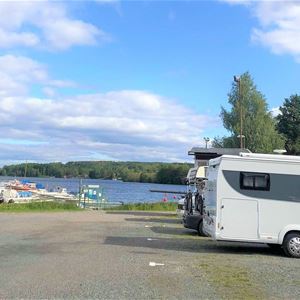 Parked motorhomes with the harbor in the background.