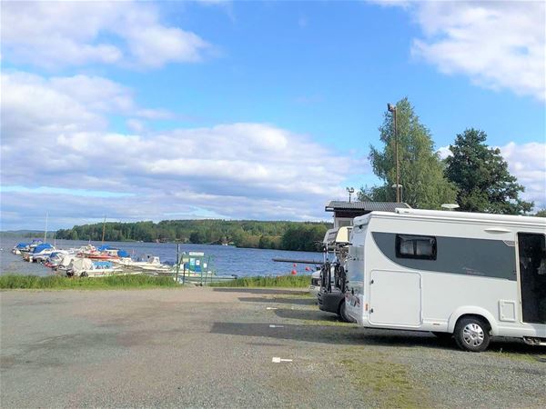 Parked motorhomes with the harbor in the background. 