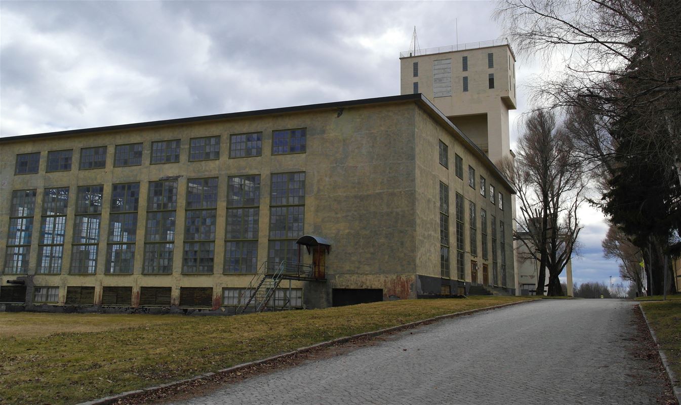 A big yellow building with large windows.