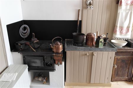 a black historic stove in a kitchen. 