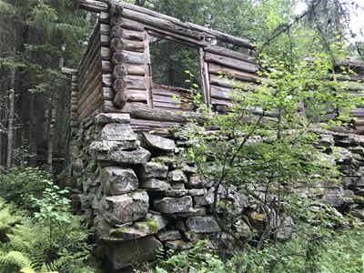 Log house with stone base.