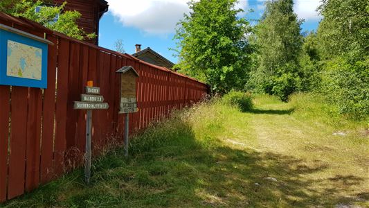 A path next to a red fence