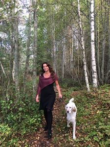 Lady and dog on a forest walk.
