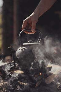 Coffee brewing over an open fire.
