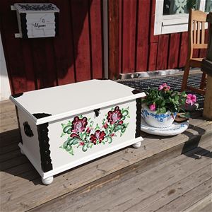 White wooden coffin with rose painting.