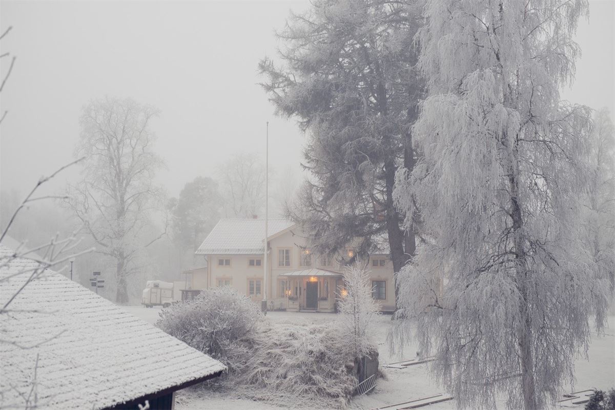 Yellow manor house in winter landscape.