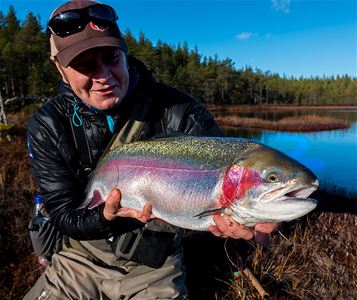 a man holding a big fish.