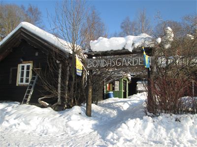 Vinter, ingång till Bondasgården med namnskylt ovanför entren. 