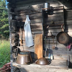 Kitchenware hanging on the outside of the chalet.