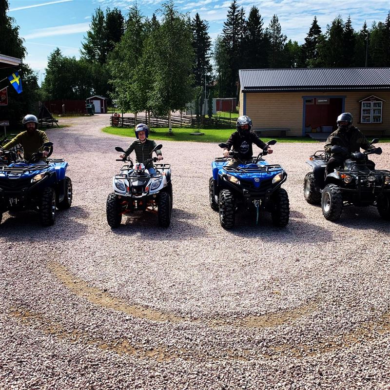 Four quad bikes with drivers. 