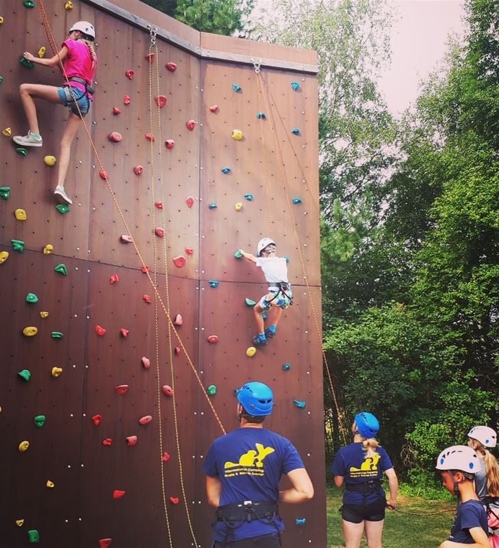 Two children on their way up in the climbing wall.