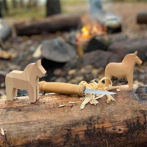 Knife and Dala horses in wood.