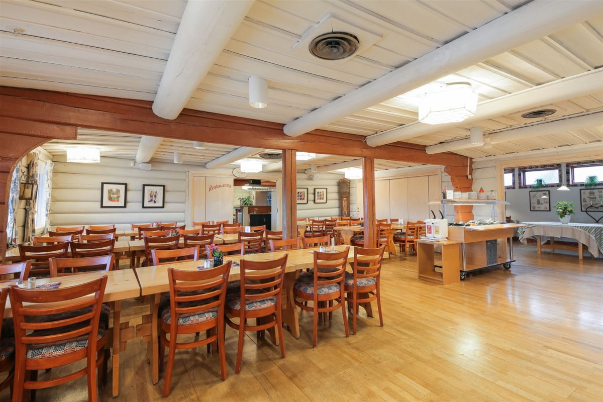 Restaurant with white timbered walls and dining furniture in pine. 