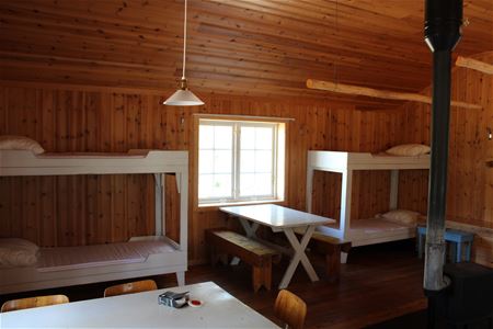 Room with two bunk beds and a fire place.