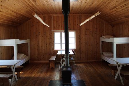 Room with two bunk beds on each corner.