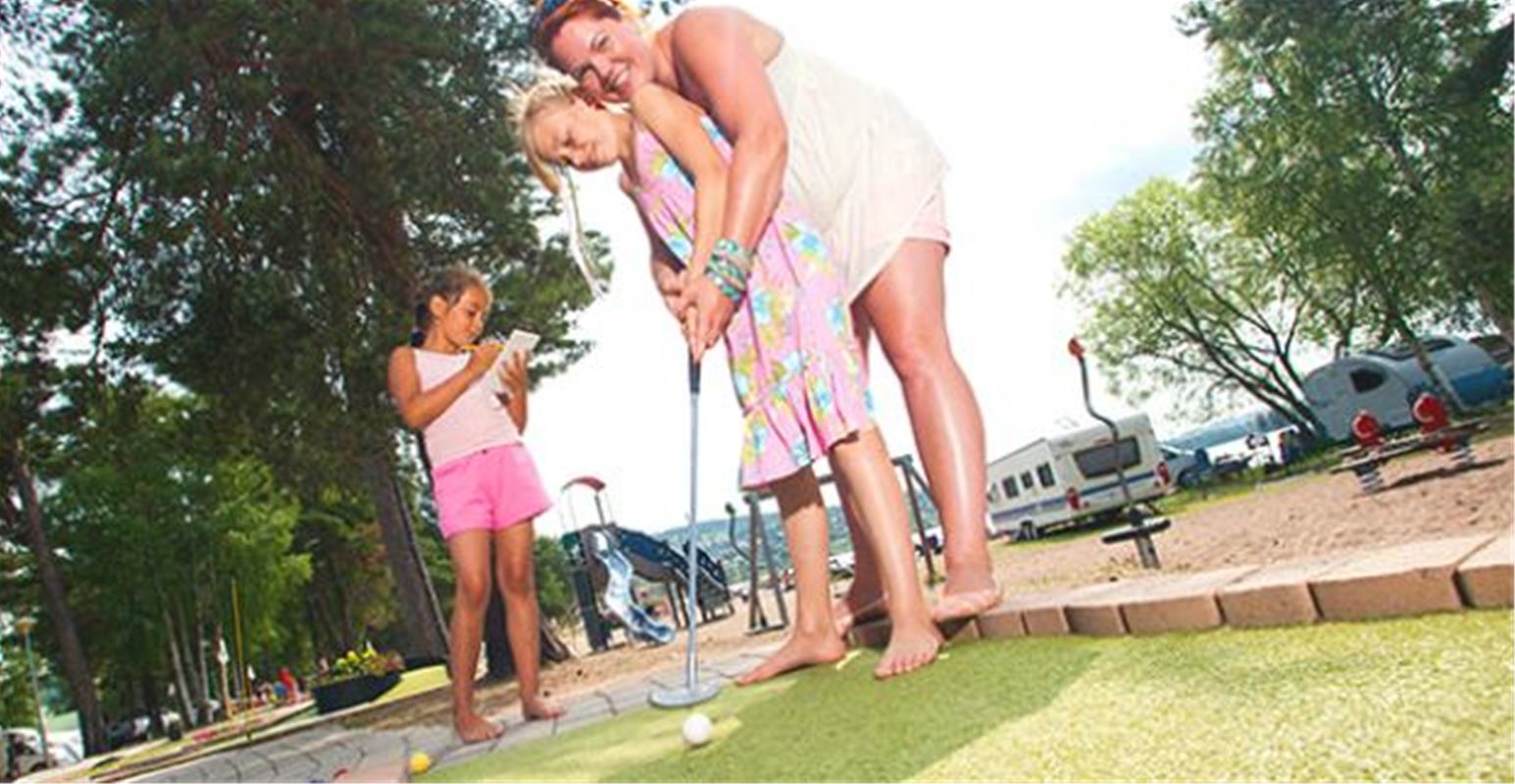 A family playing miniature golf.