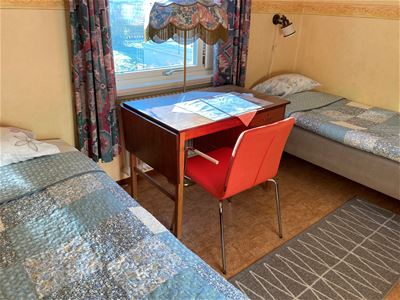 Two beds with desk in between.