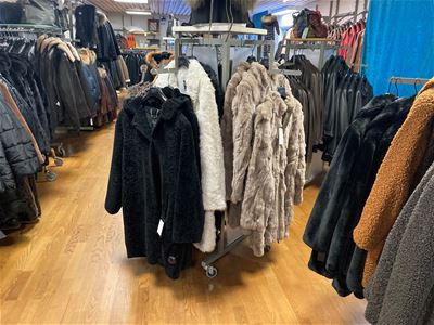 Several racks with jackets in the store.