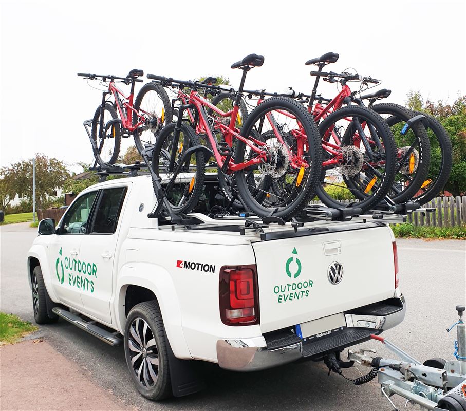 A car with several bicycles on the roof.