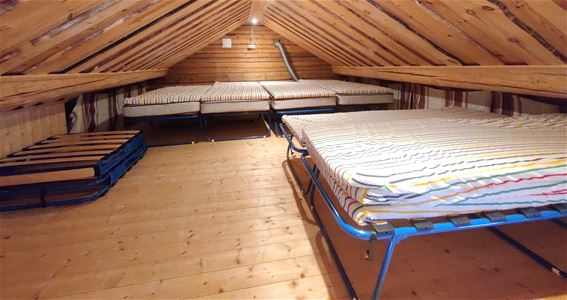 Several tent beds with thick mattresses.