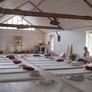 A hall with yoga mats on the floor.