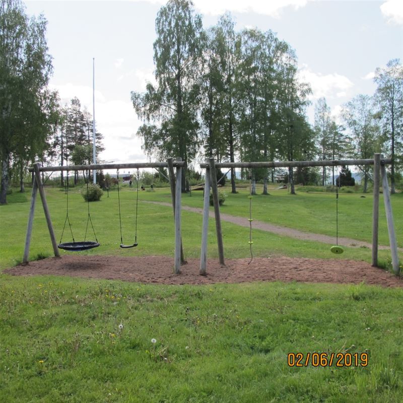 Swings on a green lawn.